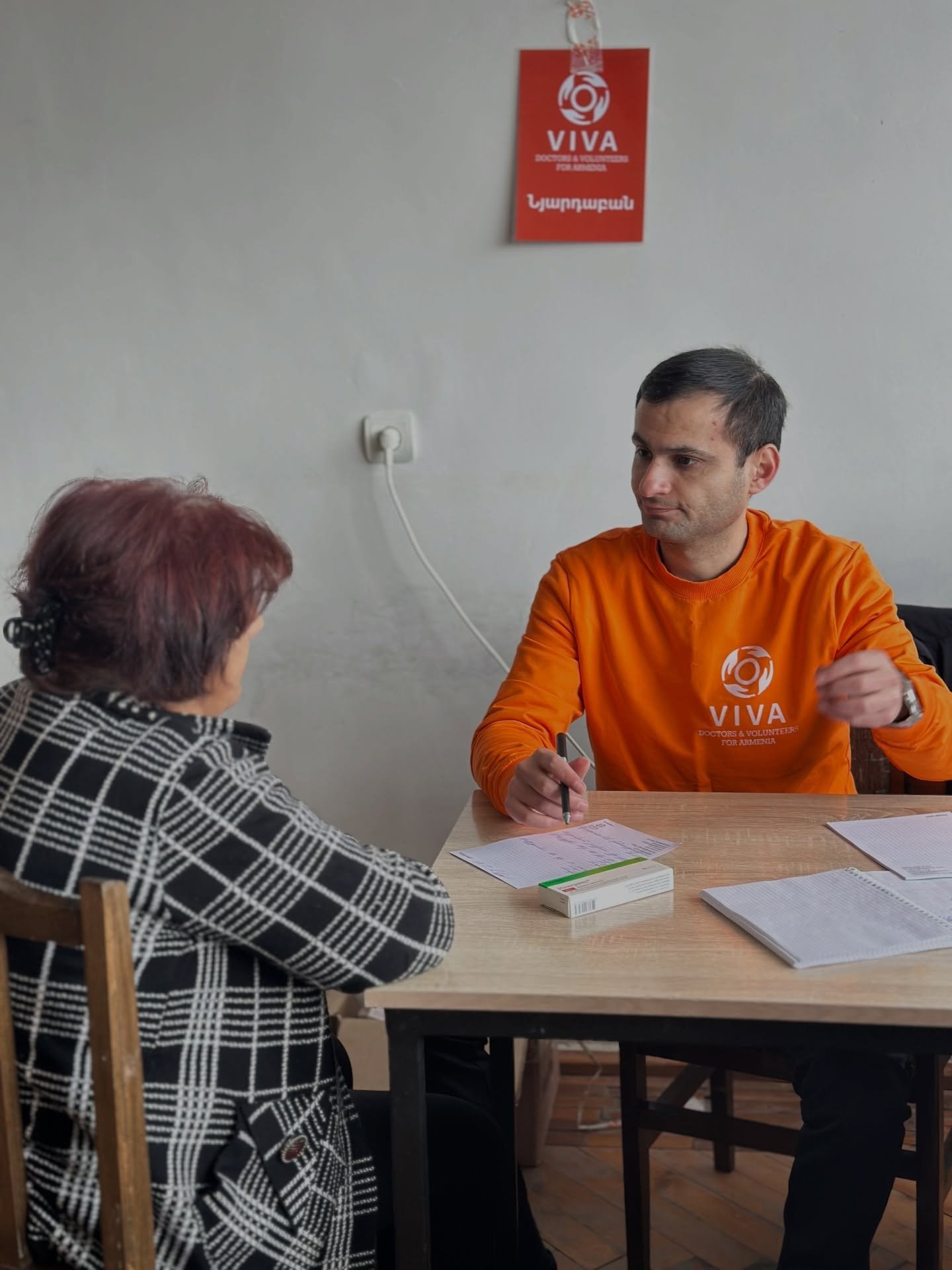 VIVA Foundation volunteer discussing medical assistance with a woman in Armenia